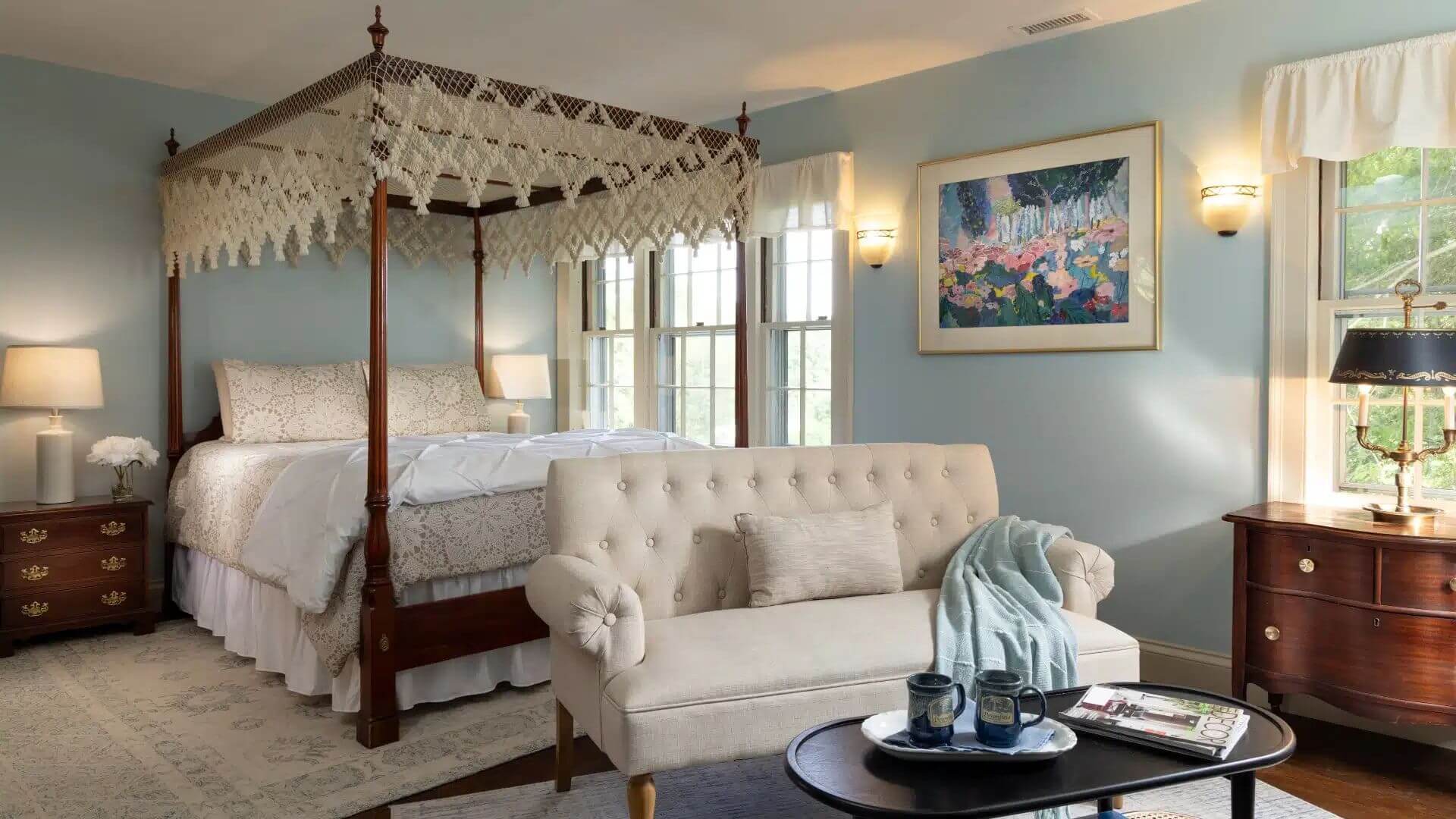 canopy bed and sitting area in the collins suite at devonfield inn