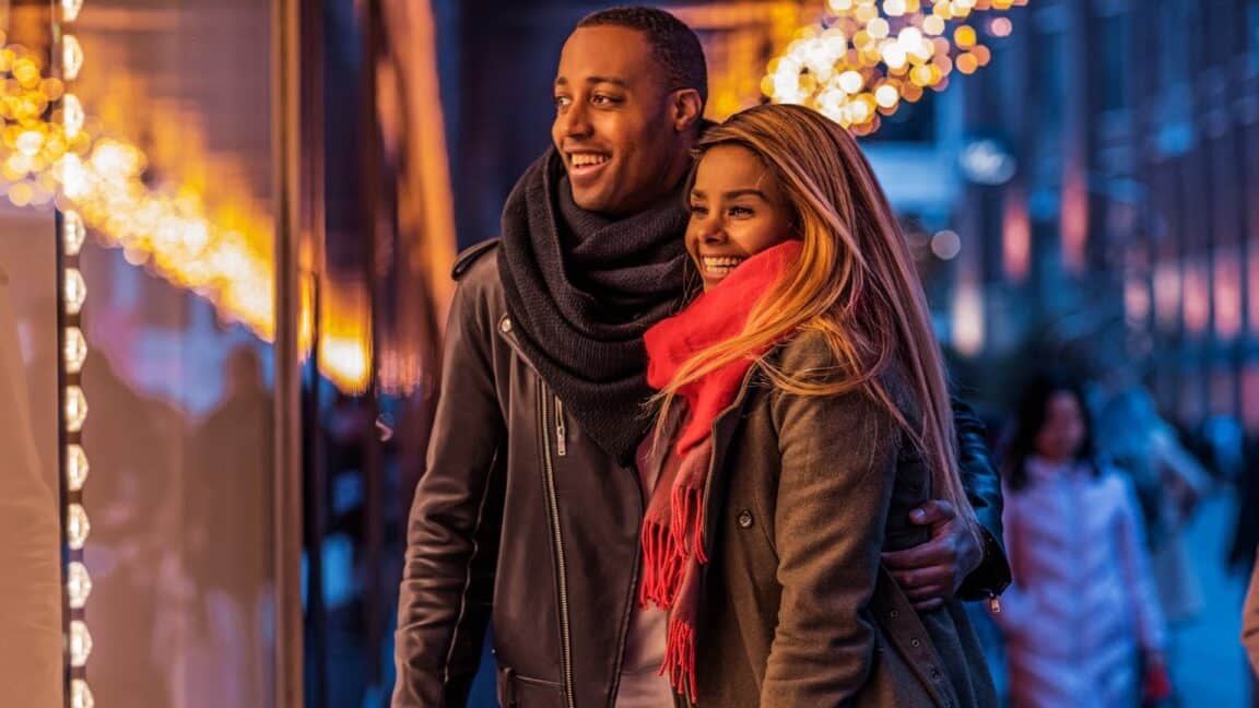 man and woman holiday window shopping