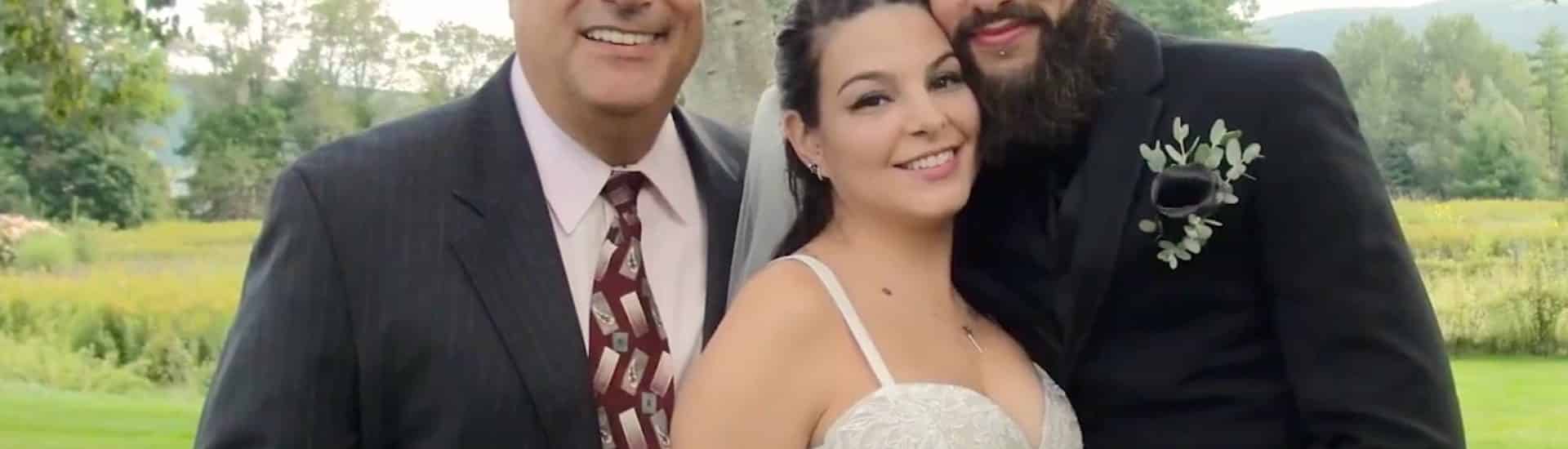 Doug Bagnasco posing as the officiant with a bridal couple