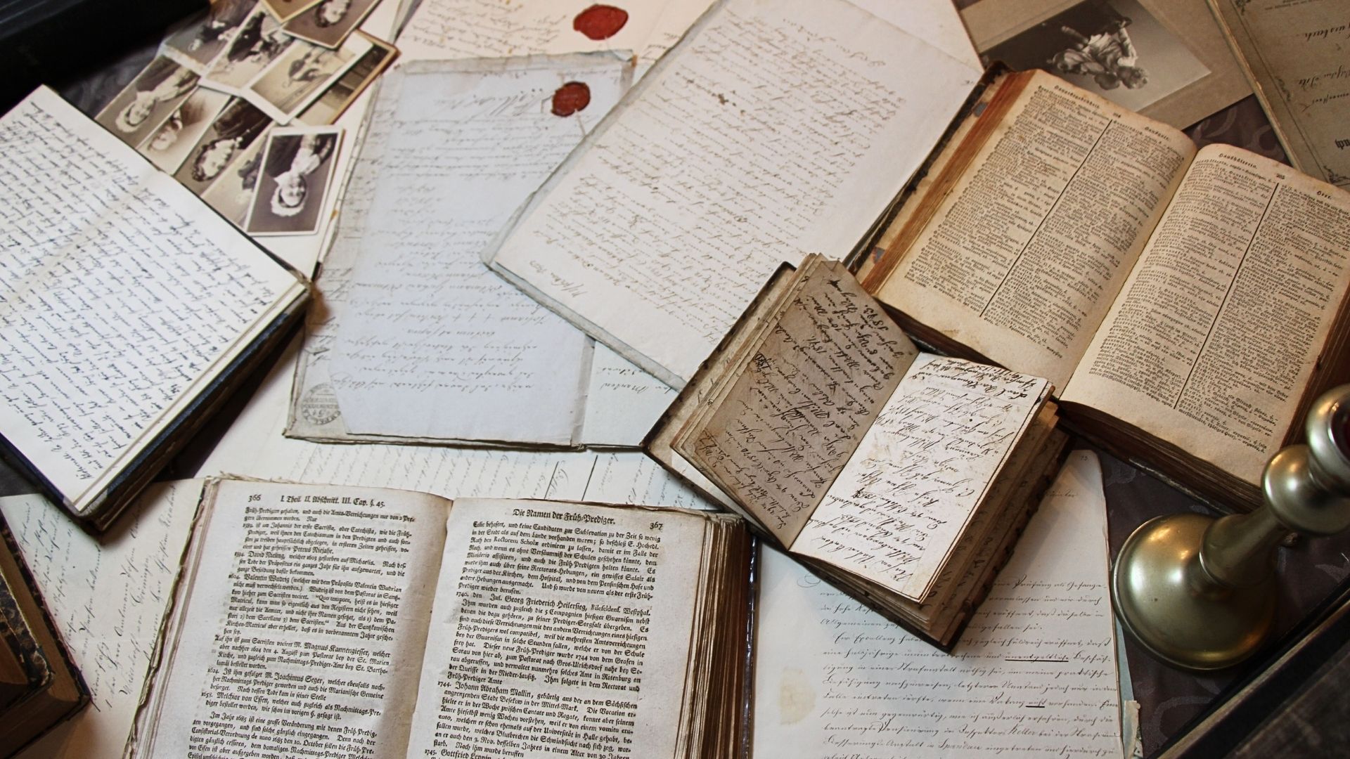 a pile of books, journals, and photographs from the 1800s